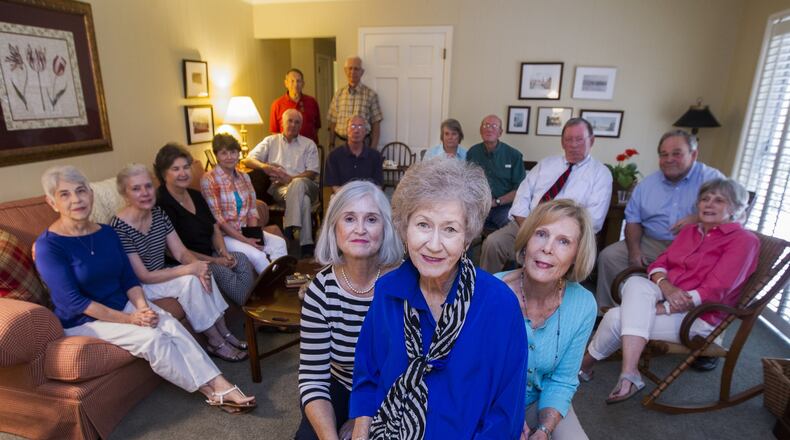 Karen McGehee, center, flanked by her friends Julianne Lovett, left, and Kay Allen, along with the rest of her friends at her home in Tallahassee. McGehee is the mother of Caroline Small who was shot and killed by police in Brunswick, Ga., in 2010. MARK WALLHEISER / SPECIAL