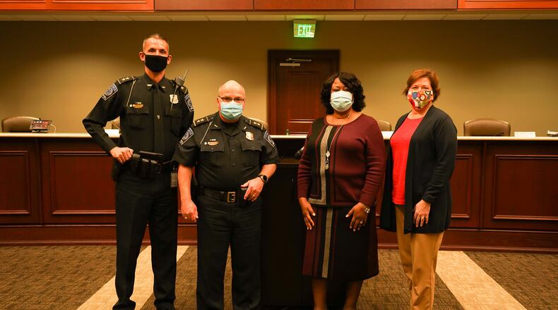 New Suwanee Police Chief Cass Mooney, retiring Chief Mike Jones, retiring City Clerk Elvira Rogers and new City Clerk Robyn O’Donnell at Suwanee's recent city council meeting. (Courtesy City of Suwanee)