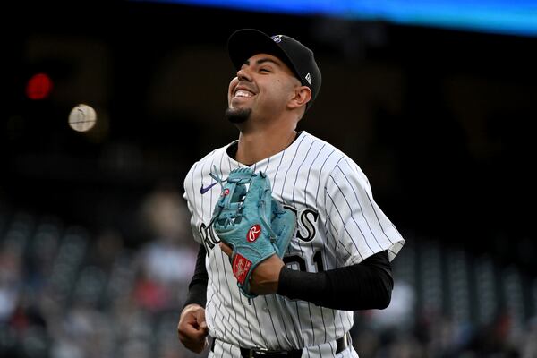 Colorado Rockies shortstop Alan Trejo (31) smiles after fielding three outs in the third inning of a baseball game against the Atlanta Braves Tuesday, April 29, 2025, in Denver. (AP Photo/Geneva Heffernan)