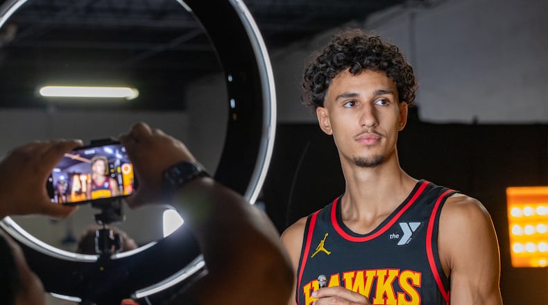 Waiting for the camera to be set, Hawks’ player Zaccharie Risacher #10, gets ready to be interviewed during media day on Monday, Sept 30, 2024 where media outlets including the Associated Press, Getty, NBA and many others gather to take photos, conduct interviews and gather footage. (Jenni Girtman for The Atlanta Journal-Constitution)