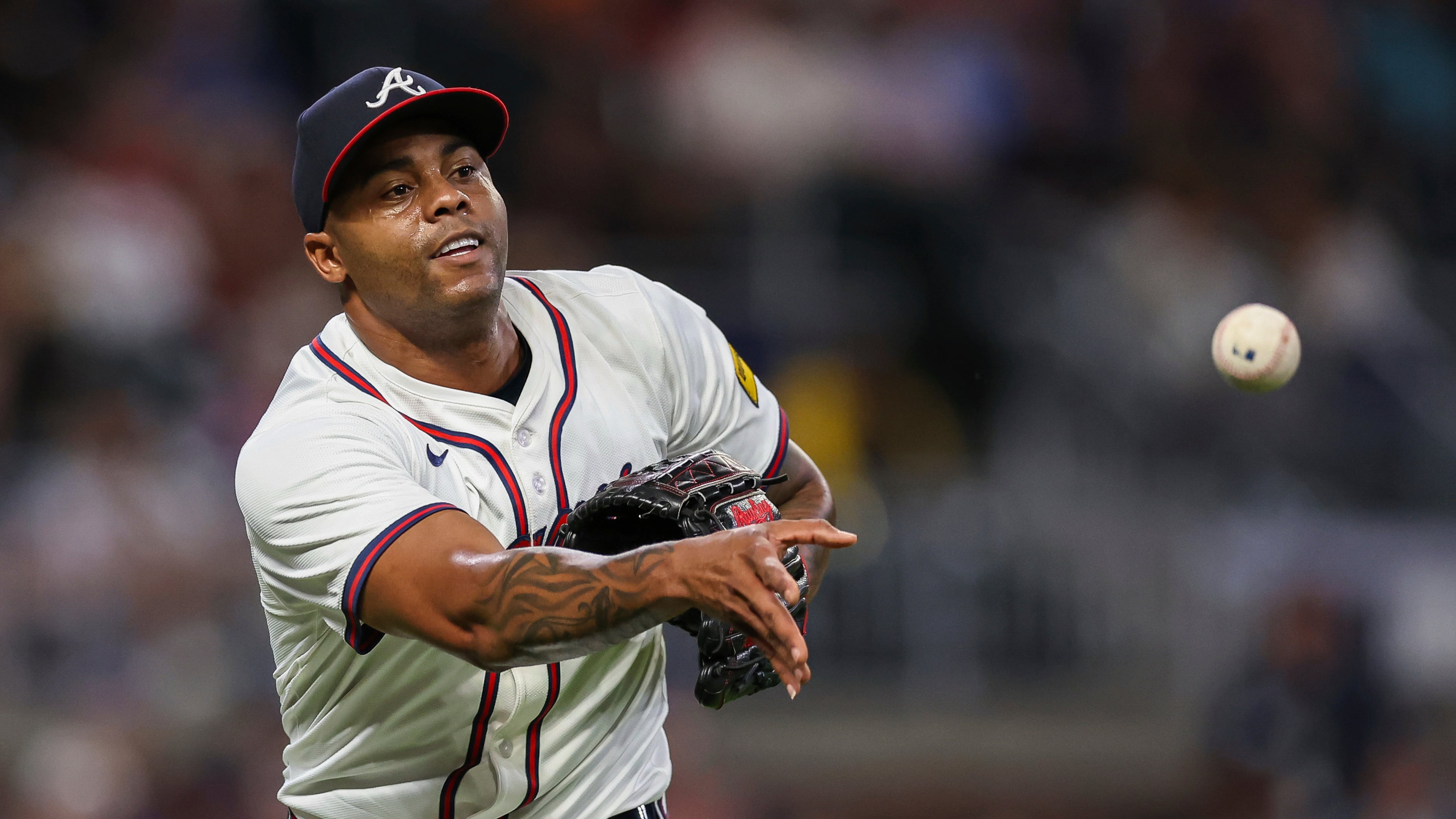 FILE- Atlanta Braves pitcher Raisel Iglesias throws to first base in the eighth inning of a baseball game against the Milwaukee Brewers, Aug. 6, 2025, in Atlanta. (AP Photo/Colin Hubbard, File)