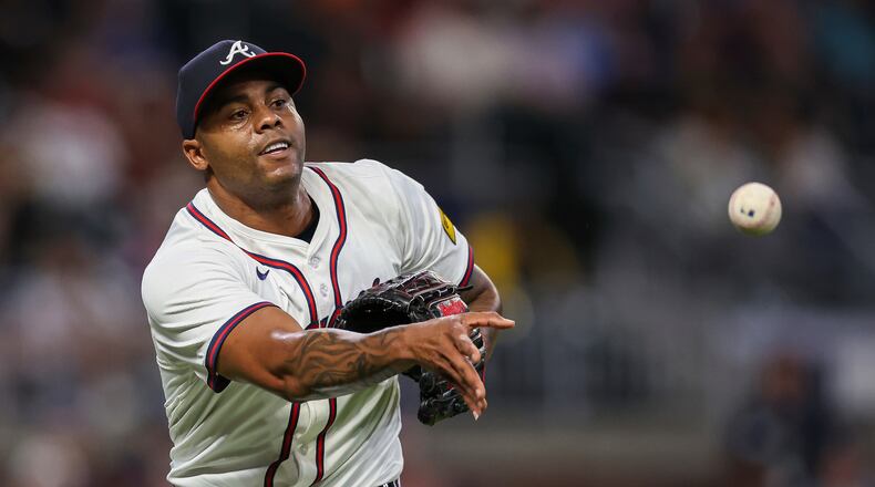 FILE- Atlanta Braves pitcher Raisel Iglesias throws to first base in the eighth inning of a baseball game against the Milwaukee Brewers, Aug. 6, 2025, in Atlanta. (AP Photo/Colin Hubbard, File)