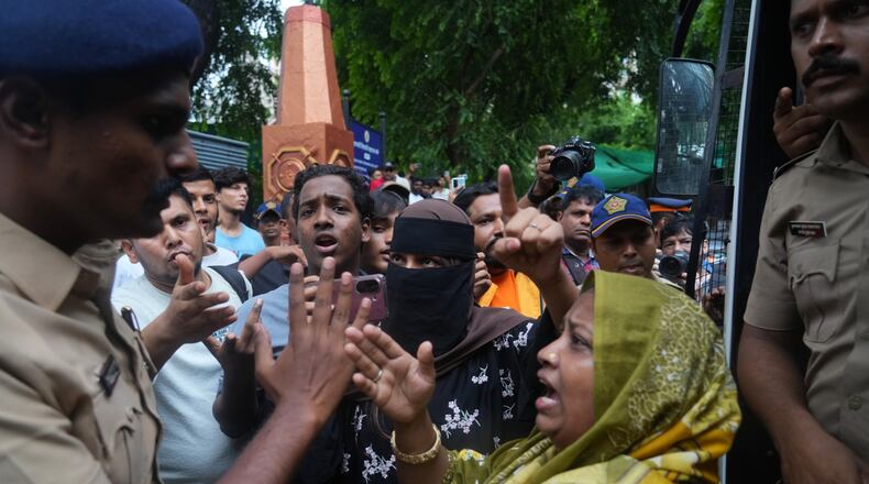 Protesters confront a police officer during a demonstration demanding educational reforms as part of the Cockroach Janta Party's ongoing protest movement in Mumbai, India, Thursday, July 23, 2026. (AP Photo/Rafiq Maqbool)