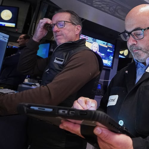 Specialist Glenn Carell, left, and trader Fred Demarco work on the floor of the New York Stock Exchange, Tuesday, Nov. 18, 2025. (AP Photo/Richard Drew)