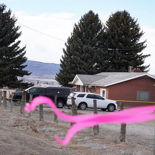 A pink ribbons hangs on a pole Thursday, March 5, 2026, in Lyman, Utah, in front of the house of a woman that was killed a day earlier. (AP Photo/George Frey)