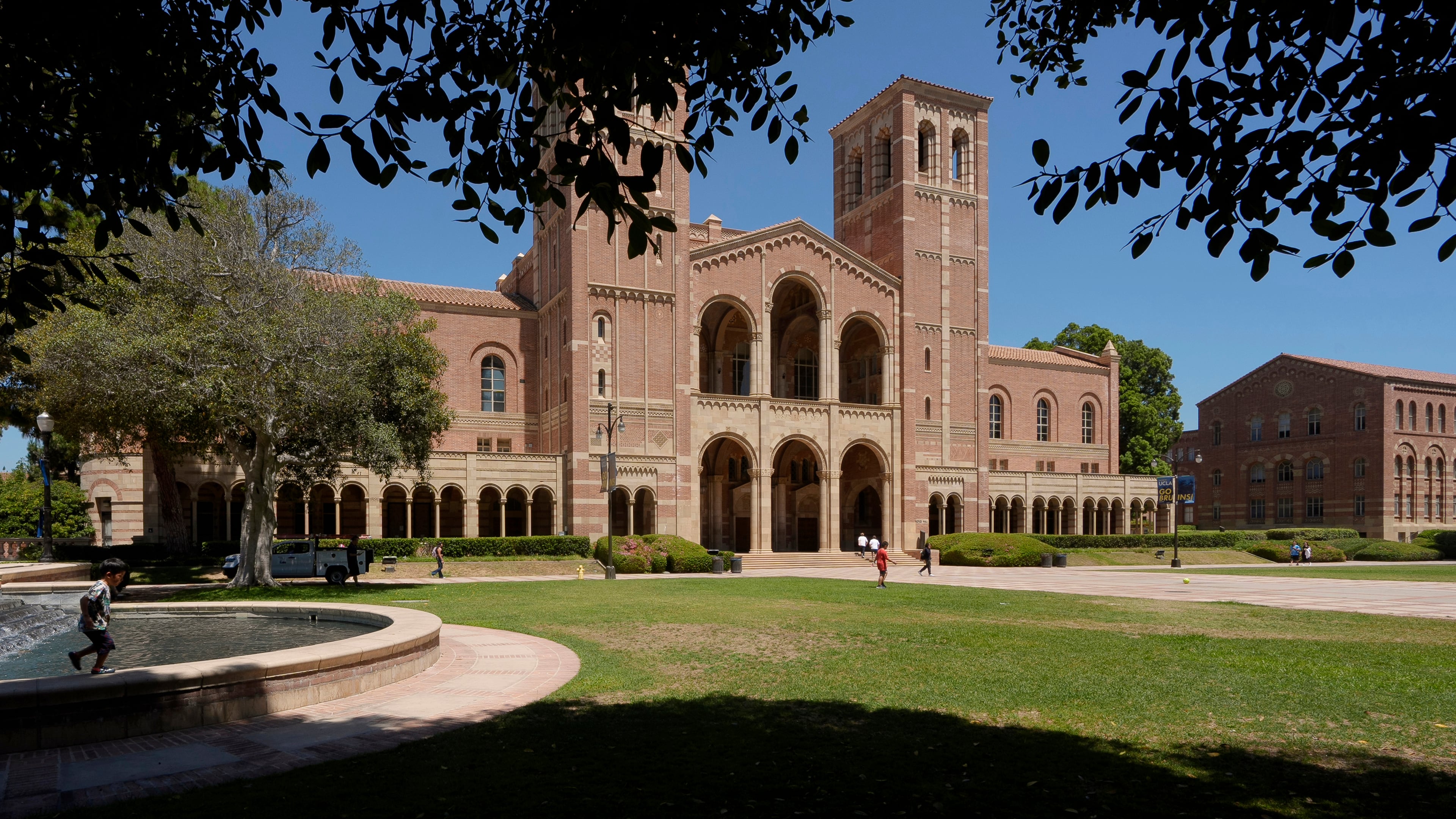 FILE - Children play outside Royce Hall at the University of California, Los Angeles, campus, Aug. 15, 2024. (AP Photo/Damian Dovarganes, File)