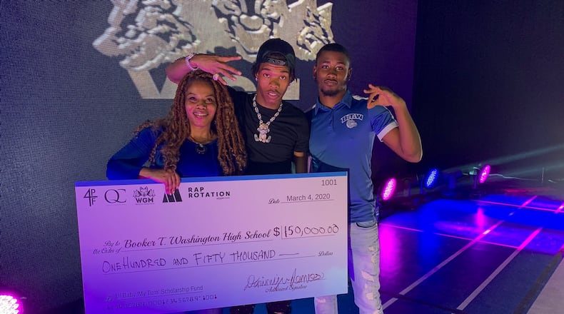 Atlanta rapper Lil Baby poses with Washington High School principal Angela Coaxum-Young (right) and scholarship recipient Vachon Raye.