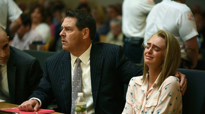 Michelle Carter, right, seated with her attorneys Cory Madera, left, and Joseph Cataldo reacts as she listens to Judge Lawrence Moniz before he finds her guilty of involuntary manslaughter in the suicide of Conrad Roy III, Friday, June 16, 2017, in Bristol Juvenile Court in Taunton, Mass. (Glenn C.Silva/Fairhaven Neighborhood News, Pool)