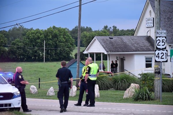 Police stand at the front of the Richmond Road Baptist Church as other officers maintain a perimeter following a shooting at the church in Lexington, Ky., Sunday, July 13, 2025. (AP Photo/Timothy D. Easley)