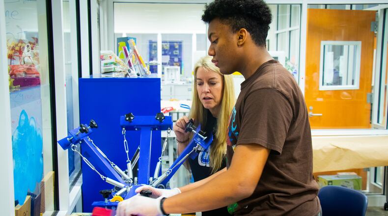 Christa Heath works with student Aaron Veschi in Centennial High's maker's space.