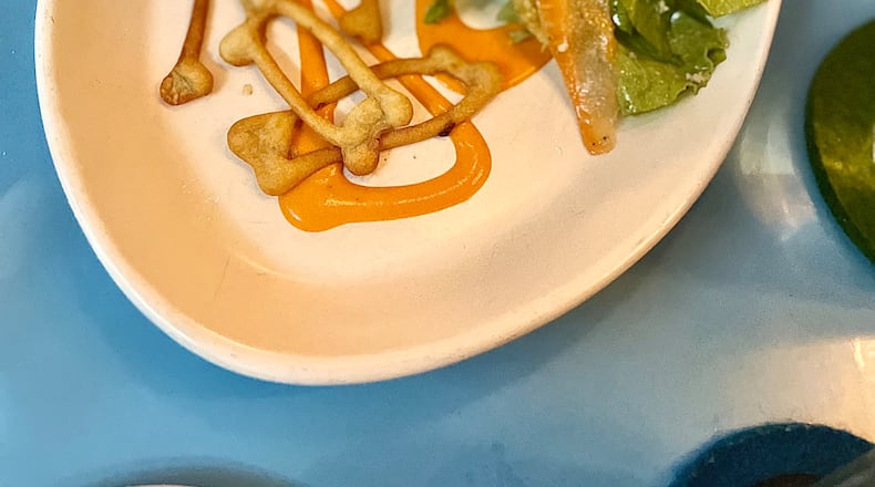 Southern Belle's lemon pepper wet chicken is served with blue cheese crackers in the shape of chicken bones. Angela Hansberger for The Atlanta Journal-Constitution