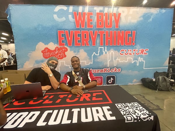 Chase Young and Sam Holland pose at their Sneaker Con table with their shop, Culture Kicks.
