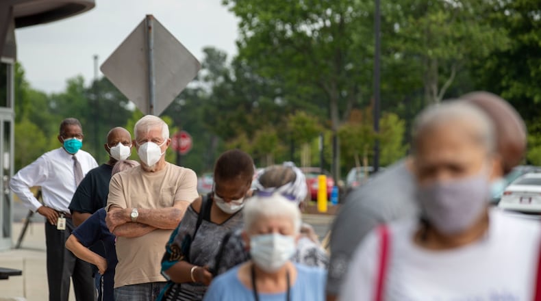 05/18/2020 - Lawrenceville, Georgia - Voters wearing face masks strand in line outside of the Gwinnett County Voter Registration and Elections Office in order to participate in early voting in Lawrenceville, Monday, May 18, 2020. Early voting began May 18 and will last three-weeks, ended June 5. Georgia's Election Day is Tuesday, June 9.(ALYSSA POINTER / ALYSSA.POINTER@AJC.COM)