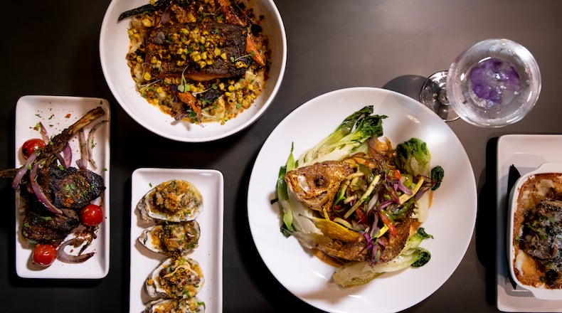 The Continent Atlanta Fried Whole Snapper, Pan Seared Salmon, Spiced Lamb Chops, Yard Man Oysters, Stush Martini and Cassava Au Gratin. (Mia Yakel for The Atlanta Journal-Constitution)