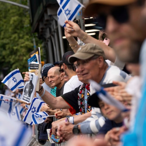 Spectators wave flags during the Israel Day Parade, Sunday, May 31, 2026, in New York. (AP Photo/Emil T. Lippe)
