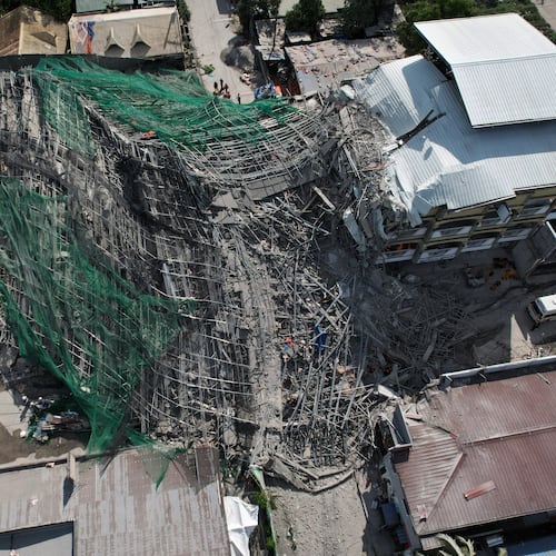 A collapsed building where multiple people are believed to be trapped in Angeles city in Pampanga province, north of Manila, Philippines Sunday, May 24, 2026. (AP Photo/Aaron Favila)