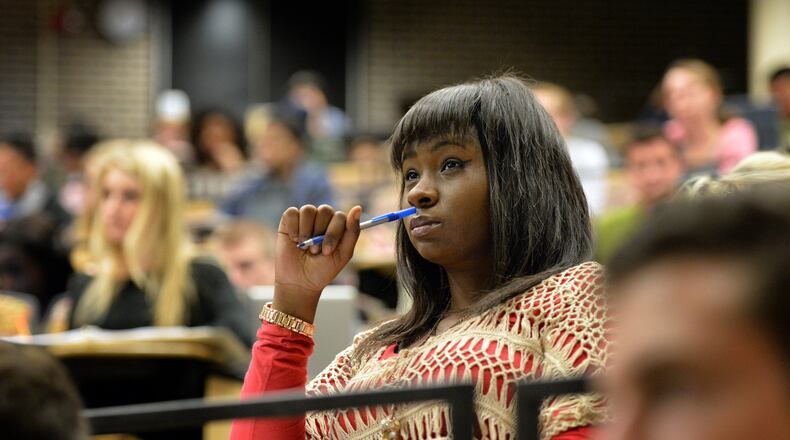 Schylundye Thomas, who is a former foster care youth and now GSU student, listens during her Accounting class at Georgia State University on Wednesday, February 19, 2014. In 2005 Georgia passed legislation granting tuition, fee and expense grants to any kid in foster care to attend any state higher education institution. Statistics show that only 2% of foster care kids graduate with a bachelor’s degree. Various state and college agencies provide outreach to these students, along with homeless students, but they say the system needs work.