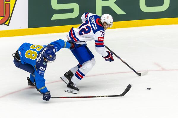 Kazakhstan's defender Tamirlan Gaitamirov, left, vies for the puck with USA's forward Tage Thompson, during the IIHF 2025 World Championship preliminary round group B game between Kazakhstan and USA, at the Jyske Bank Boxen, in Herning, Denmark, Sunday, May 18, 2025. (Salvatore Di Nolfi/Keystone via AP)