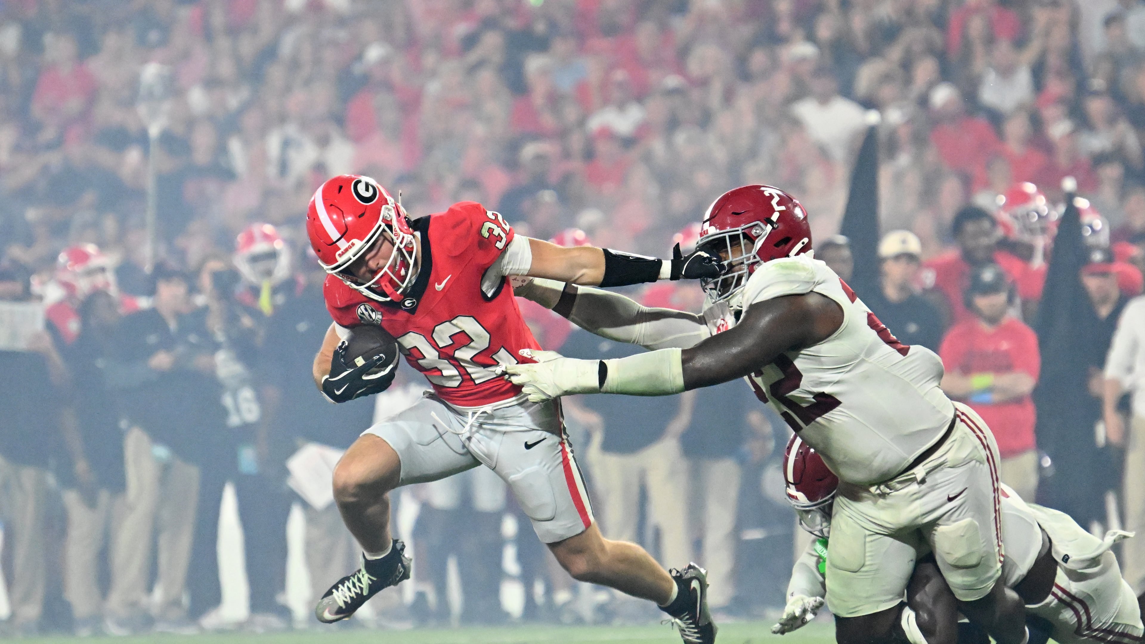Georgia running back Cash Jones (32) gets tackled by Alabama defensive lineman LT Overton (22) during the second half in an NCAA football game at Sanford Stadium, Saturday, September 27, 2025, in Athens. Alabama won 24-21 over Georgia. (Hyosub Shin / AJC)