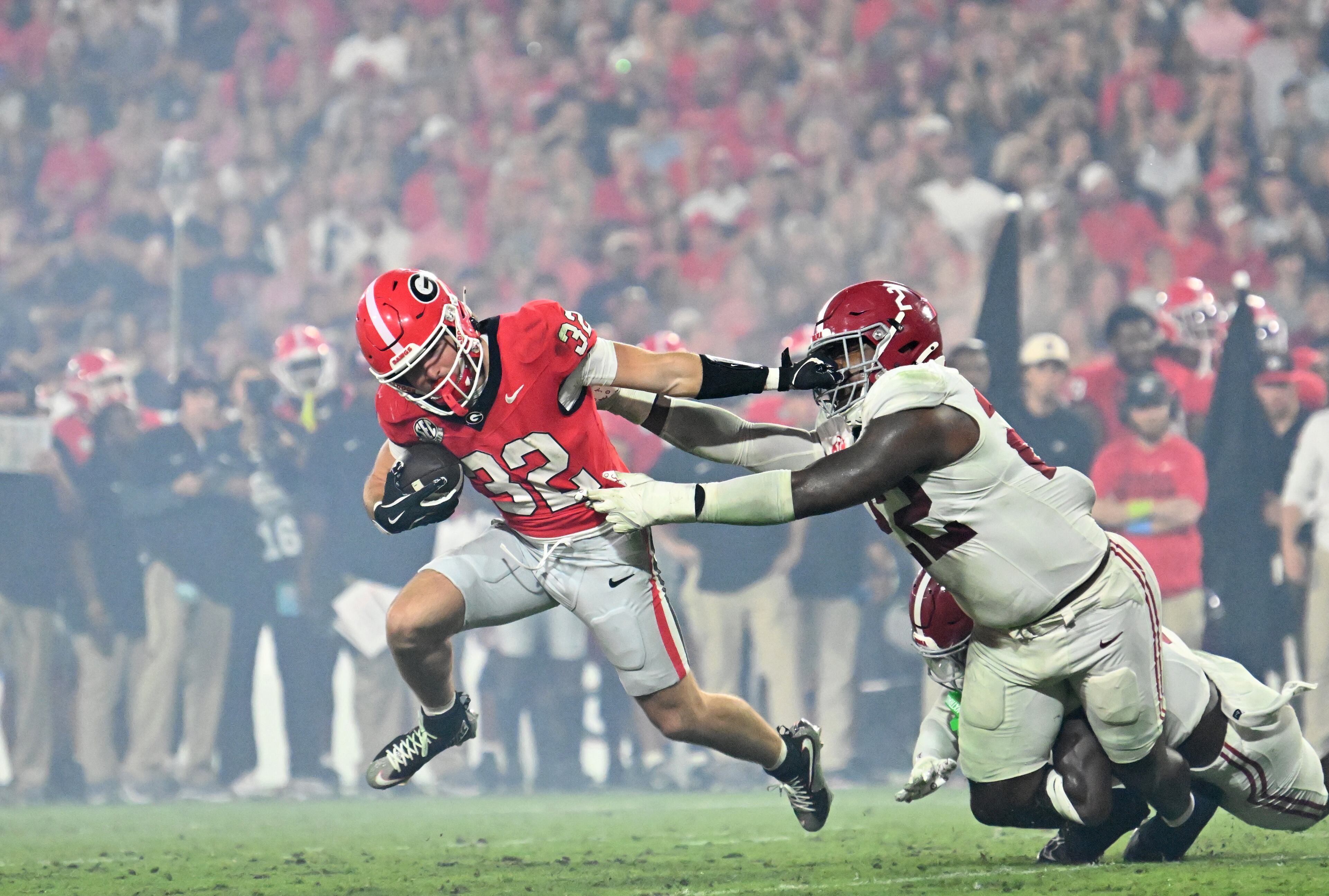 Georgia running back Cash Jones (32) gets tackled by Alabama defensive lineman LT Overton (22) during the second half in an NCAA football game at Sanford Stadium, Saturday, September 27, 2025, in Athens. Alabama won 24-21 over Georgia. (Hyosub Shin / AJC)