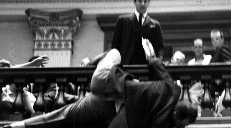 In 1964, state Rep. Denmark Groover, D-Macon, nearly fell over the state House railing trying to adjust the hands of the clock to keep it from reaching the mandatory hour of adjournment on the last day of the legislative session. The clock ended up falling. The lawmaker did not. Joe McTyre / The Atlanta Journal-Constitution