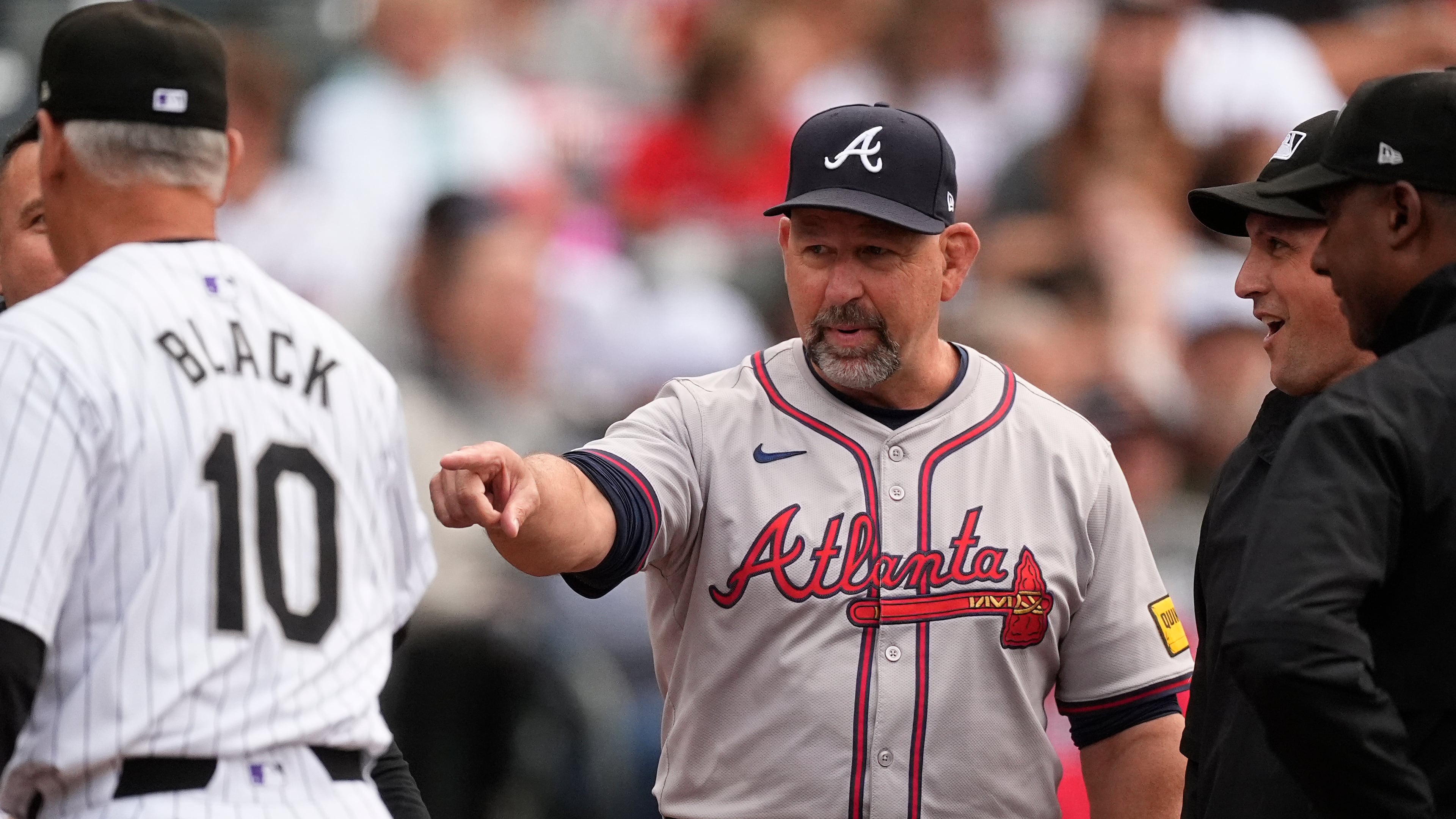 FILE - Atlanta Braves bench coach Walt Weiss, right, points to Colorado Rockies manager Bud Black before the first inning of a baseball game Aug. 9, 2024, in Denver. (AP Photo/David Zalubowski, File)