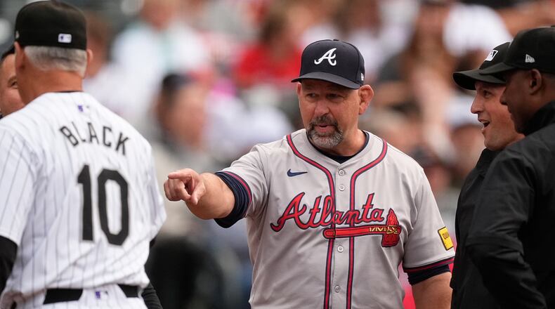 FILE - Atlanta Braves bench coach Walt Weiss, right, points to Colorado Rockies manager Bud Black before the first inning of a baseball game Aug. 9, 2024, in Denver. (AP Photo/David Zalubowski, File)