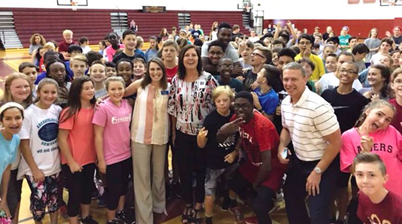 School Board Member Kelly Poole, center, stops by the gym to see physical education classes in action at Mill Creek Middle School during the first week of school, Aug. 4, 2017. CHEROKEE COUNTY SCHOOLS