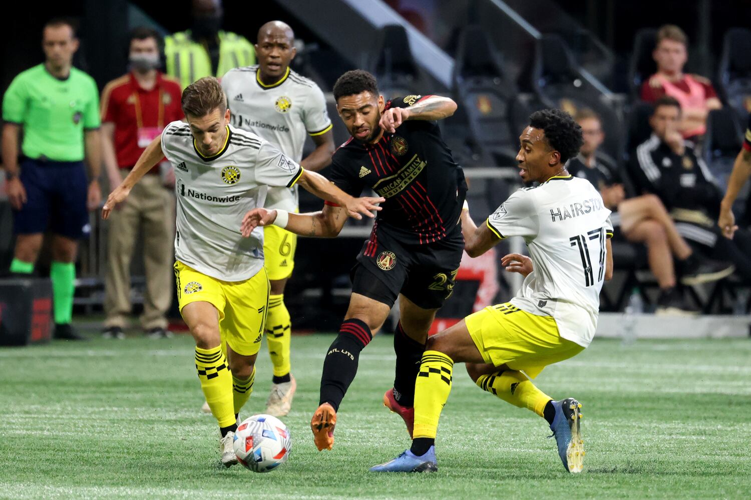 Atlanta United midfielder Jake Mulraney (23) is fouled on the play by Columbus Crew forward Pedro Santos (7, left) and midfielder Marlon Hairston (17). JASON GETZ FOR THE ATLANTA JOURNAL-CONSTITUTION