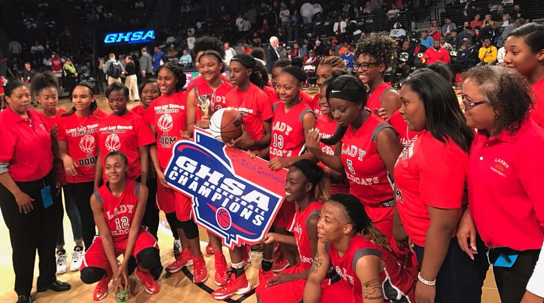 The Laney Lady Wildcats pose as De'Sha Benjamin holds the trophy following the Class AA championship win over Rabun County.