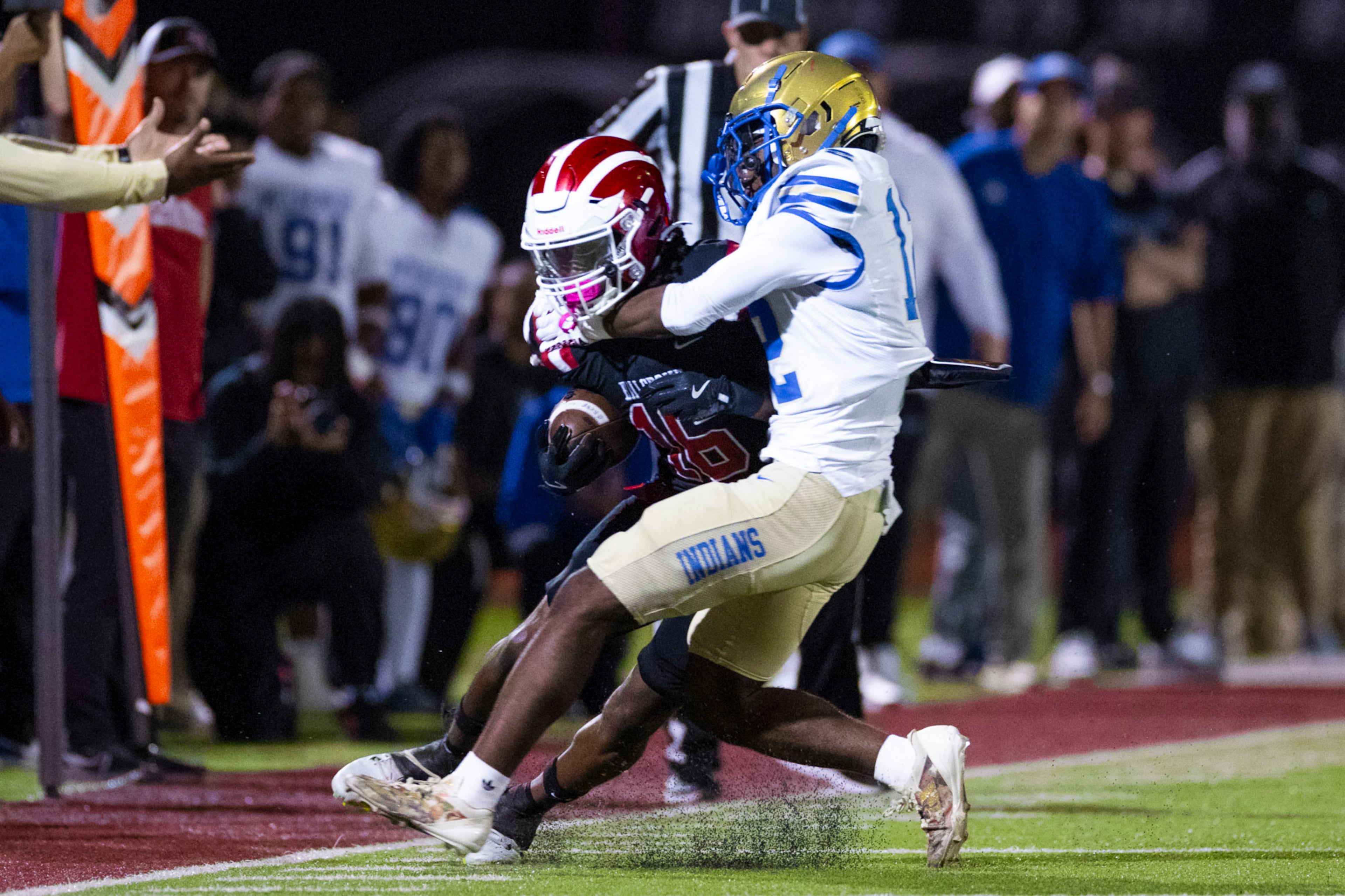 Hillgrove wide receiver Preston Wooten (16) gets tackled by McEachern quarterback Calvin Pittman Jr (12) at Cobb Energy Hillgrove Stadium in Powder Springs, GA on Friday, October 17th, 2025. (Oscar Guevara Saenz for the AJC)