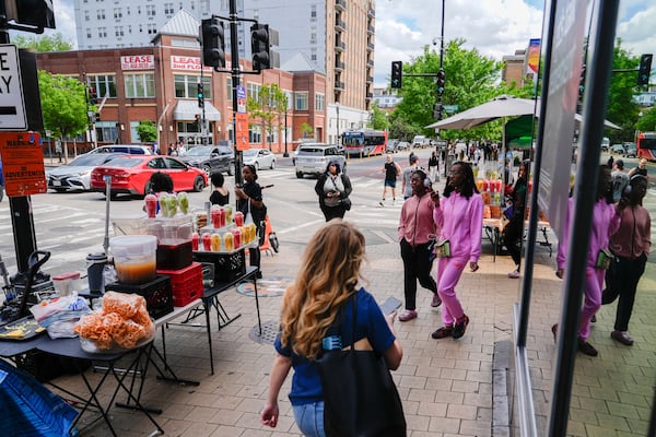 People walk past fruit vendors, Tuesday, May 6, 2025, in the Columbia Heights neighborhood of Washington. (AP Photo/Julia Demaree Nikhinson)