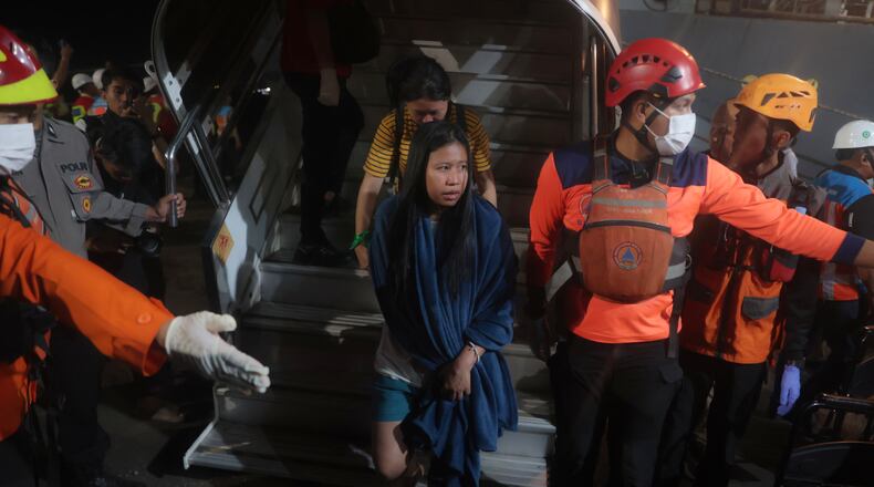 Survivors of a ferry fire arrive at Tanjung Perak Port in Surabaya, East Java, Indonesia, Monday, Aug. 3, 2026. (AP Photo/Trisnadi)