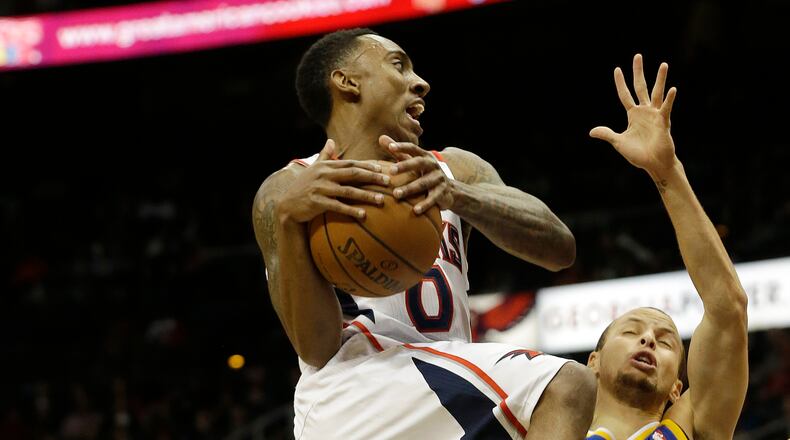 Atlanta Hawks point guard Jeff Teague (0) drives against Golden State Warriors point guard Stephen Curry (30) in the first half of an NBA basketball game on Friday, Jan. 3, 2014, in Atlanta. (AP Photo/John Bazemore)