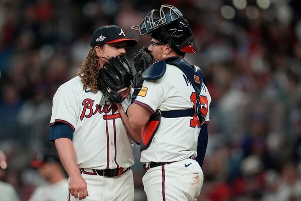 Atlanta Braves' Grant Holmes. left, and Sean Murphy (12) speak on the mound in the fourth inning of a baseball game against the Philadelphia Phillies, Wednesday, April 9, 2025, in Atlanta. (AP Photo/Mike Stewart)