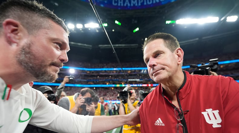 A Fox analyst says Indiana head coach Curt Cignetti (right) has done more with less than Georgia's head coach and should be ranked higher. (Brynn Anderson/AP)