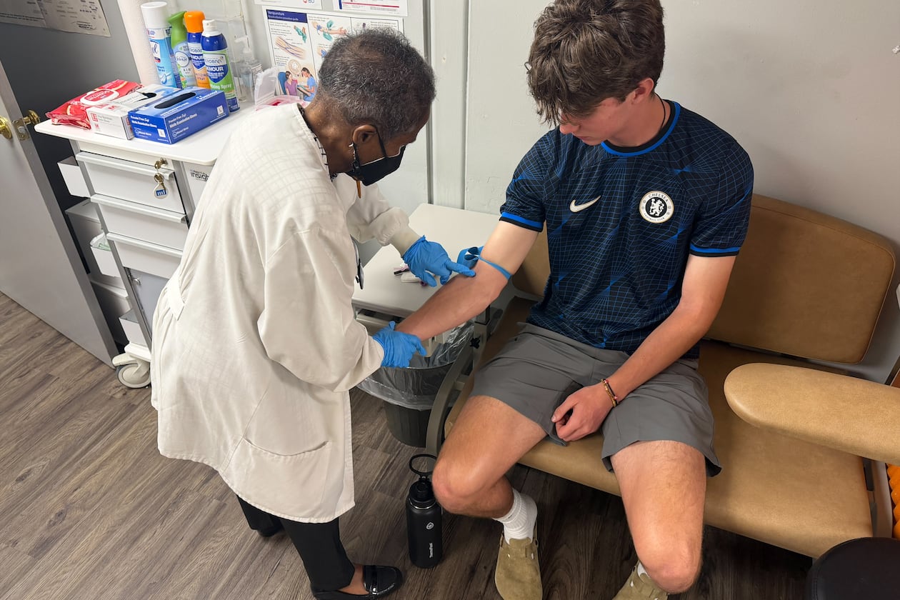 Jackie George, the Sickle Cell Foundation of Georgia, Inc.'s certified hemoglobinopathy counselor, attends to a patient. (Courtesy)