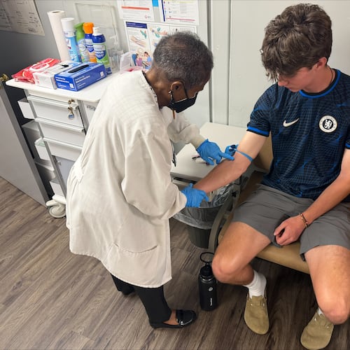 Jackie George, the Sickle Cell Foundation of Georgia, Inc.'s certified hemoglobinopathy counselor, attends to a patient. (Courtesy)