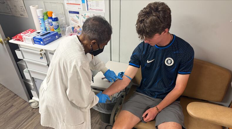 Jackie George, the Sickle Cell Foundation of Georgia, Inc.'s certified hemoglobinopathy counselor, attends to a patient. (Courtesy)