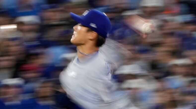 Los Angeles Dodgers pitcher Yoshinobu Yamamoto throws against the Toronto Blue Jays during the second inning in Game 2 of baseball's World Series, Saturday, Oct. 25, 2025, in Toronto. (AP Photo/Brynn Anderson)