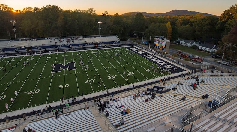 Friday Night Lights: The sun sets over Northcutt Stadium in Marietta as the Marietta Blue Devils warm up before a regular-season game against Hillgrove. (Daniel Varnado/Special)