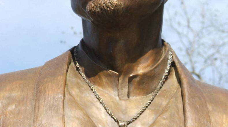 In this file photo, a life-size bronze statue of Tupac Shakur presides over the "Peace Garden" at the Tupac Amaru Shakur Center for the Arts in Stone Mountain. The statue left after the center closed.