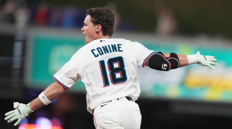 Miami Marlins' Griffin Conine (18) reacts after hitting a walk off single to score Heriberto Hernández and defeat the Philadelphia Phillies in the the ninth inning of a baseball game, Monday, July 27, 2026, in Miami. (AP Photo/Lynne Sladky)