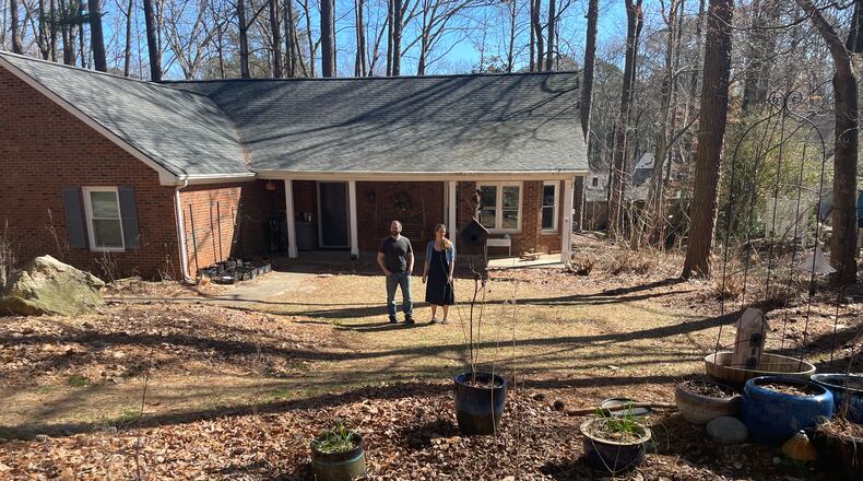 Sean Crews and Gail Gustavson, a young couple in Cobb County, have been trying to change their suburban lot into a wildlife habitat. Someone complained. (Bill Torpy/AJC)