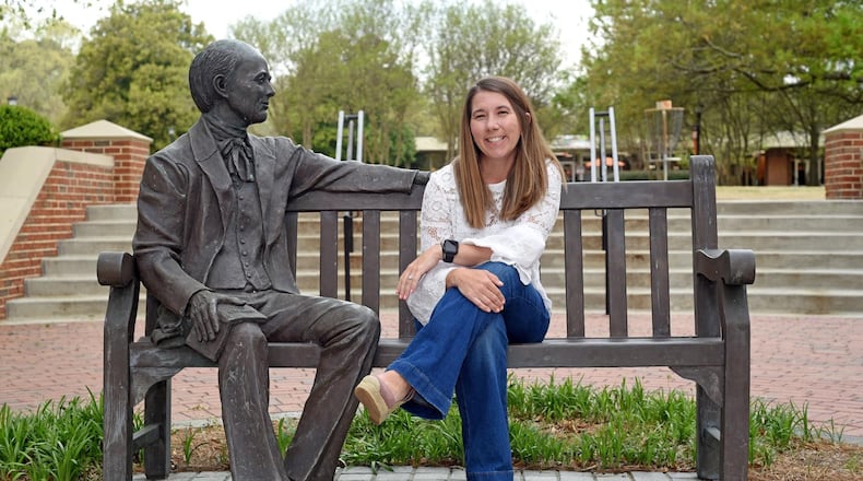 Rev. Ashley Brock Guthas in a photo taken on Mercer University's Atlanta campus sitting next to a statue of Jesse Mercer, the schol's namesake. Guthas is the new pastor for Maranatha Baptist Church in Plains, Georgia.