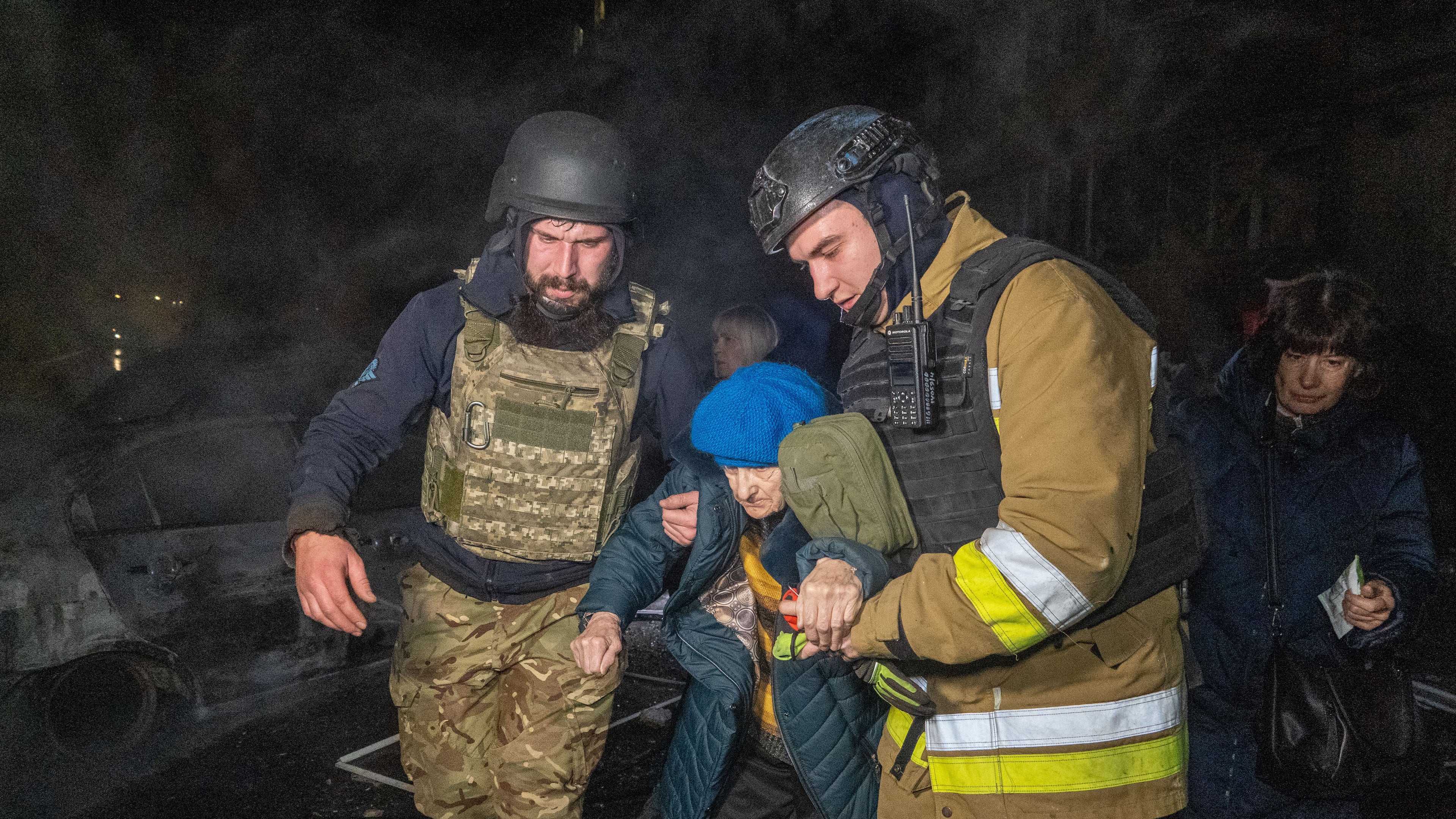 Rescuers evacuate an elderly woman after a residential building was hit following Russia's missile attack in Kharkiv, Ukraine Wednesday, Nov. 19, 2025. (AP Photo/Andrii Marienko)