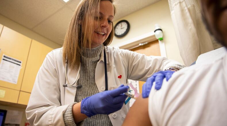 Kelly Moran, a nurse practitioner from south Philadelphia, gives a flu shot to a patient at a CVS Minute Clinic in January 2020. (Tyger Williams/The Philadelphia Inquirer/TNS)