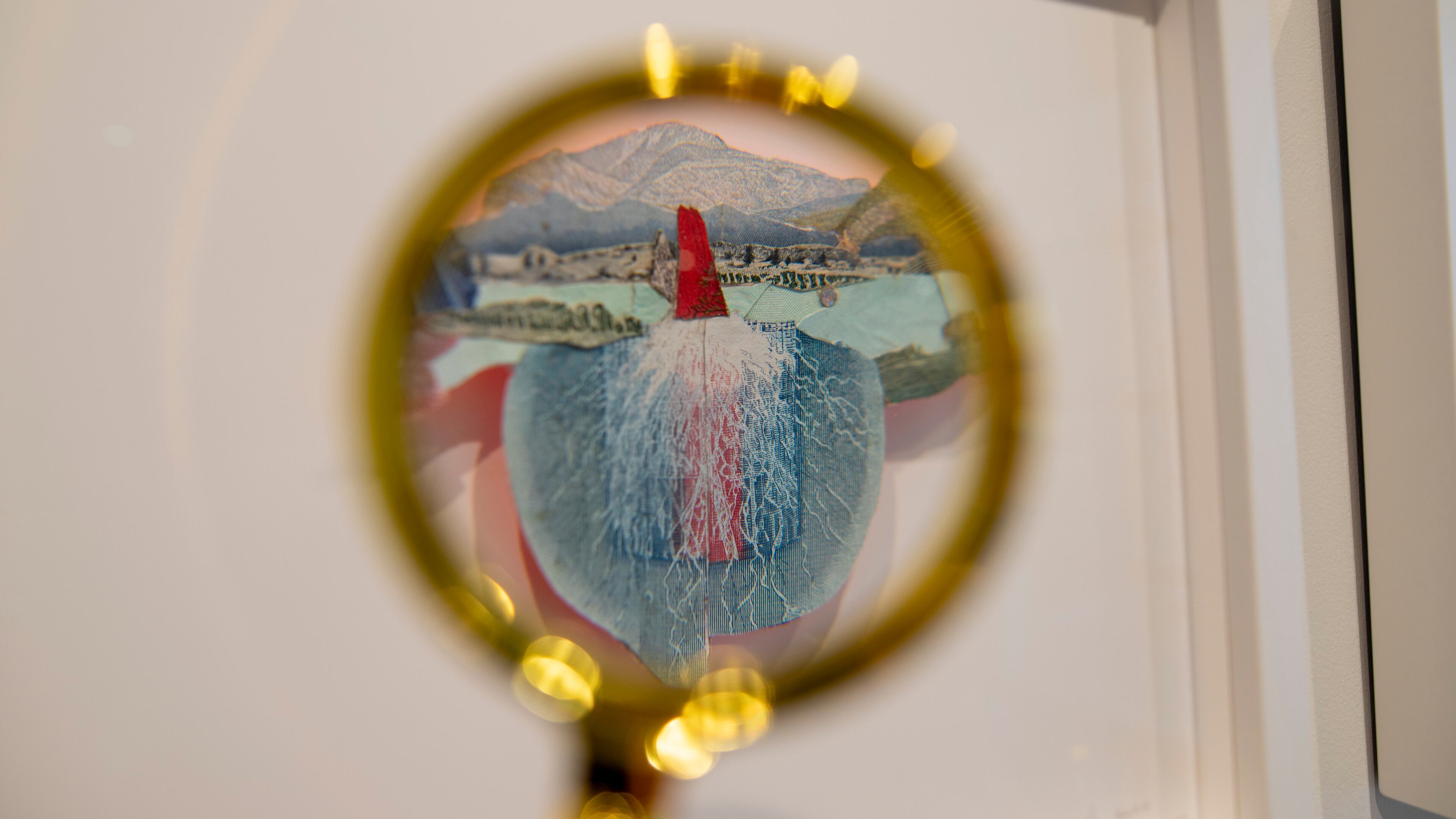 At Sandler Hudson Gallery’s front desk, magnifying glasses are available to guests who want to take a closer look at Pam Longobardi's micro collages and other works. (Courtesy of Isadora Pennington)
