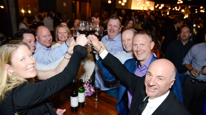 Kevin O'Leary toasts with staff of a company he partially owns called IOU Central, which lends money to small businesses. CREDIT: Tomas Espinoza