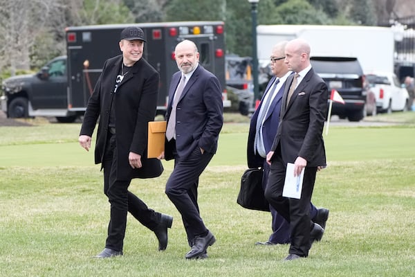 FILE - From left, Elon Musk, Commerce Secretary Howard Lutnick, Steven Cheung and Stephen Miller walk to board Marine One with President Donald Trump on the South Lawn of the White House, March 14, 2025, in Washington. (AP Photo/Alex Brandon, File)